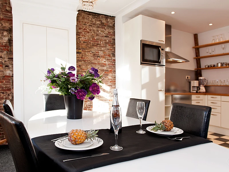 Dining table with the view of kitchen other angle Canal Holiday apartment Amsterdam