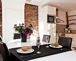 Dining table with the view of kitchen other angle Canal Holiday apartment Amsterdam