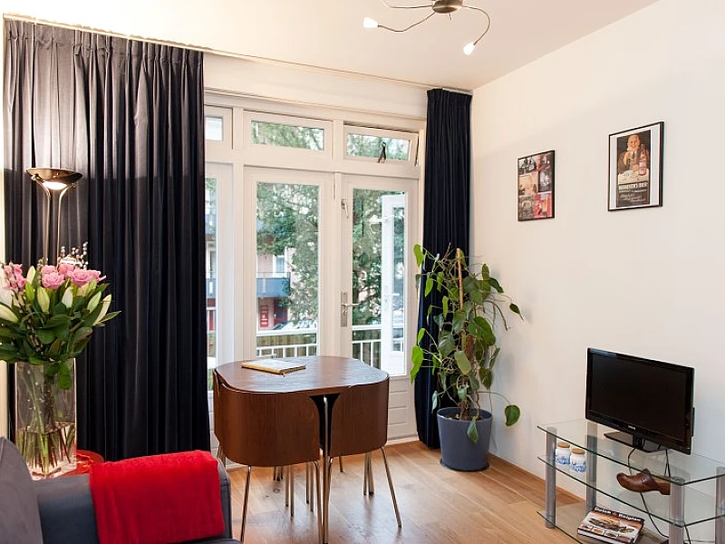 Dining Area Overview with Plasma TV West City apartment Amsterdam