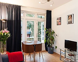 Dining Area Overview with Plasma TV West City apartment Amsterdam